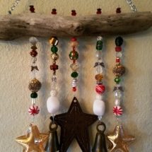 Driftwood decorated with festive Christmas beads